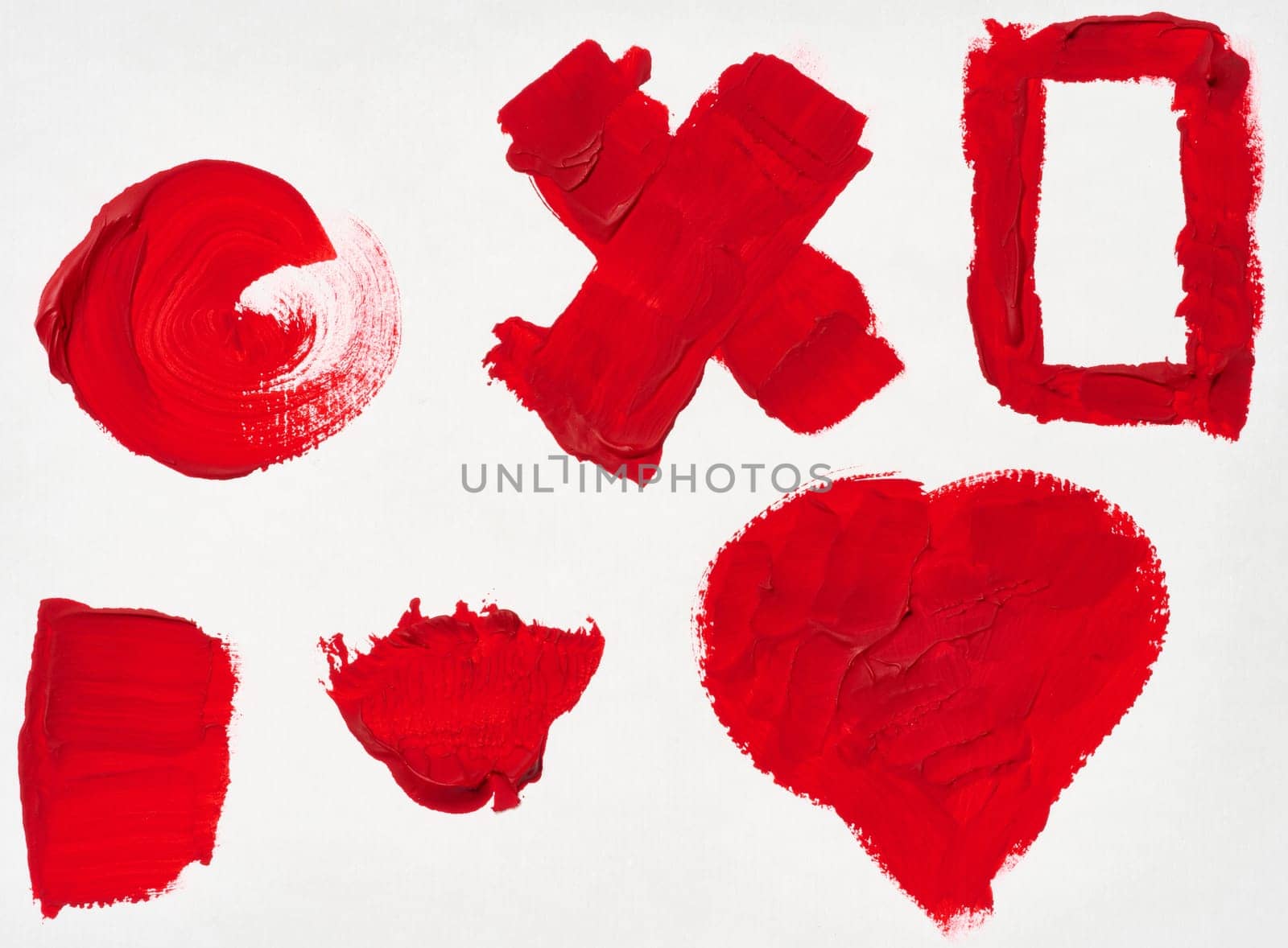 Various strokes of red gouache paint on a white sheet of paper