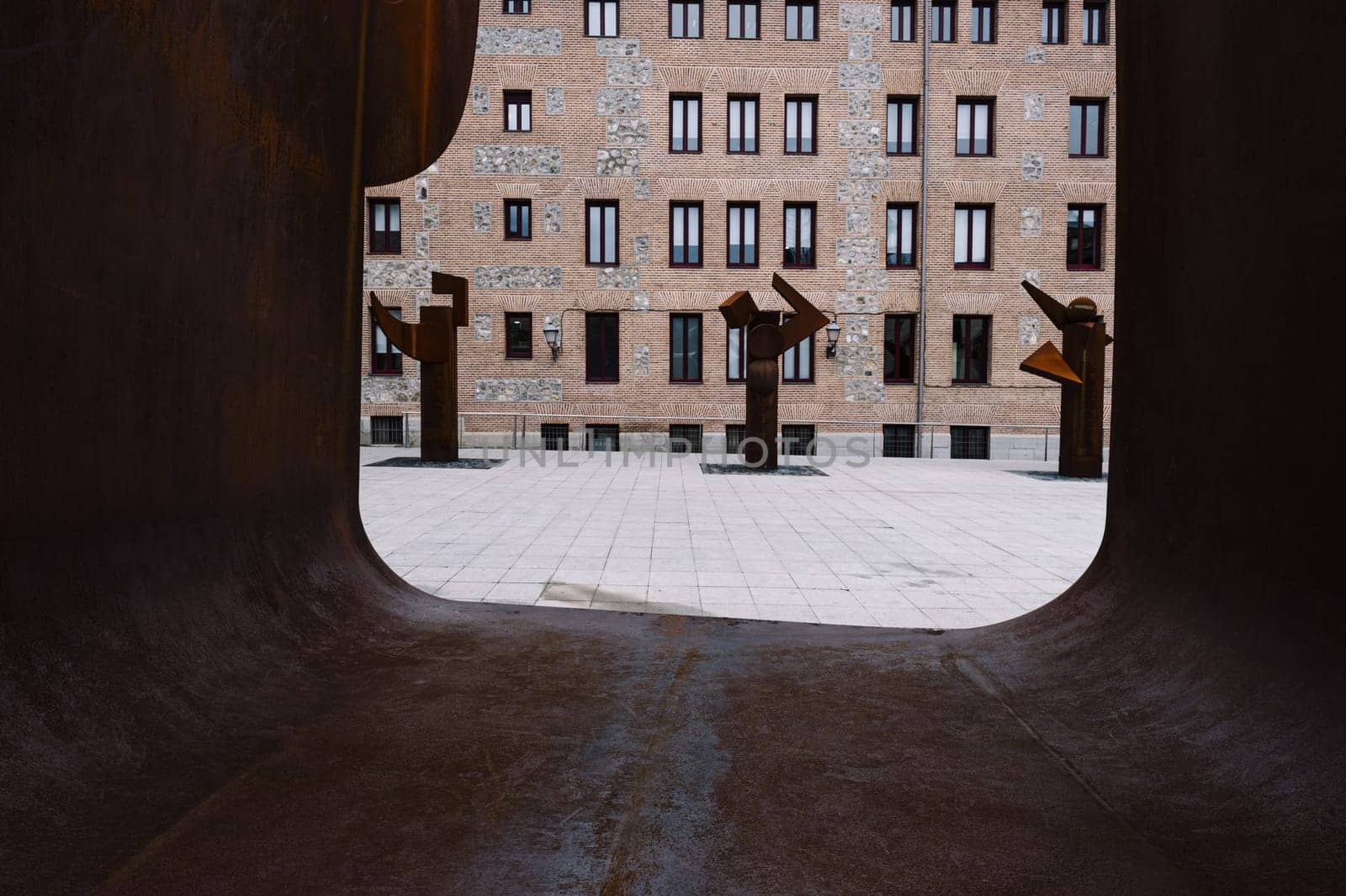 View of the Plaza del Rollo in Madrid, Spain through the sculpture symbolising the Puerta de la Libertad (Gate of Frredom), a memorial dedicated to the Madrilenians deported to Mauthausen. Visible are the three columns called Los Árboles de los Sueños (The Trees of Dreams) that complete the work of sculptor José Miguel Utande.