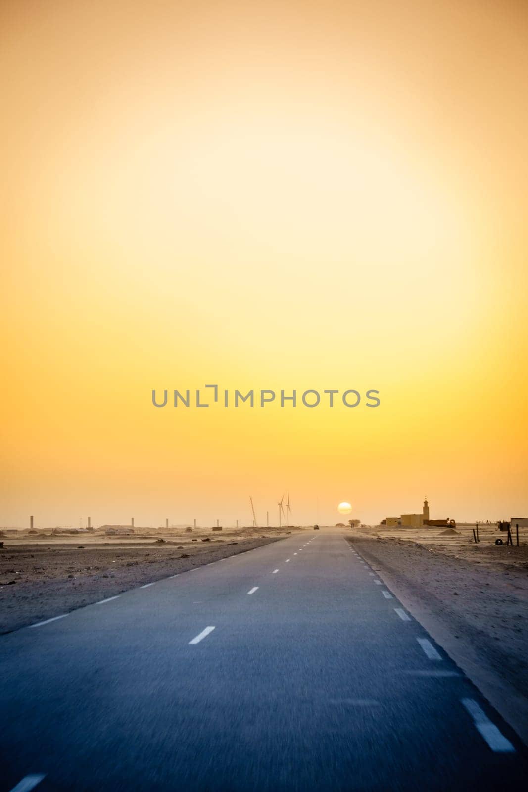 Driving through a village in the desert in Mauritania at sunset