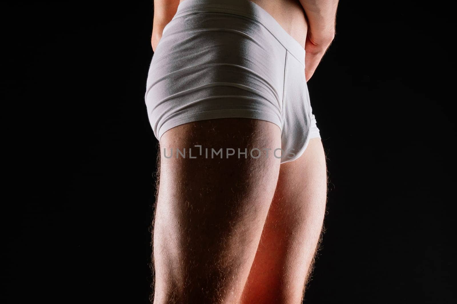 Male muscular legs body-building, muscle man in a white sport panties