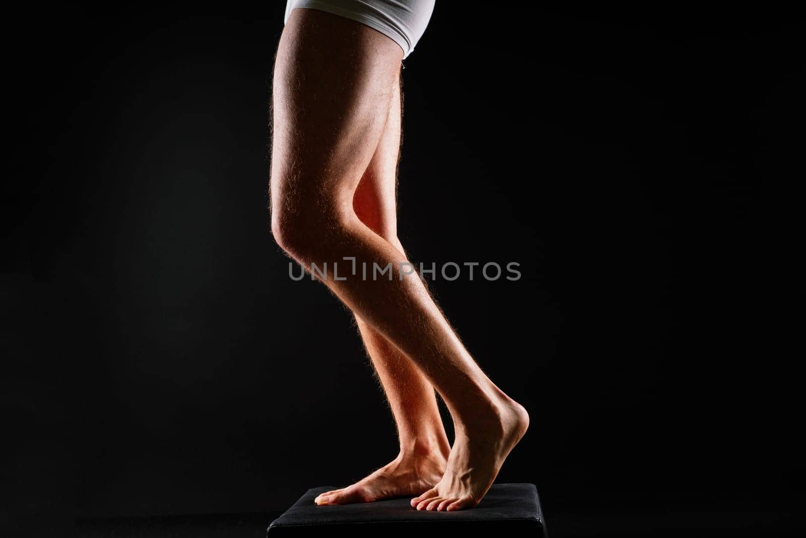 Male muscular legs body-building, muscle man in a white sport panties