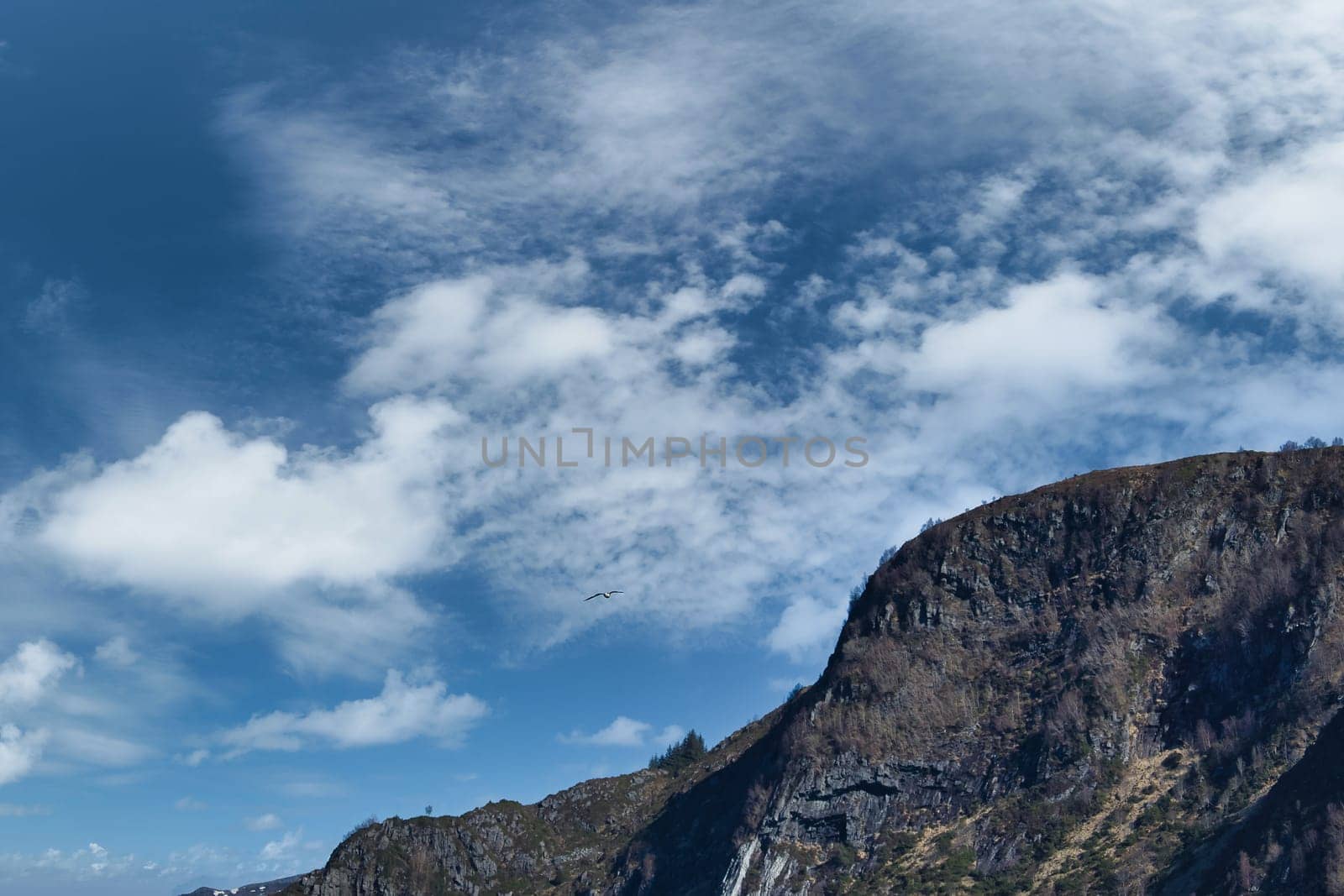 Westcap in Norway. Mountain that reaches into the fjord. Cloudy sky. Landscape shot from Scandinavia