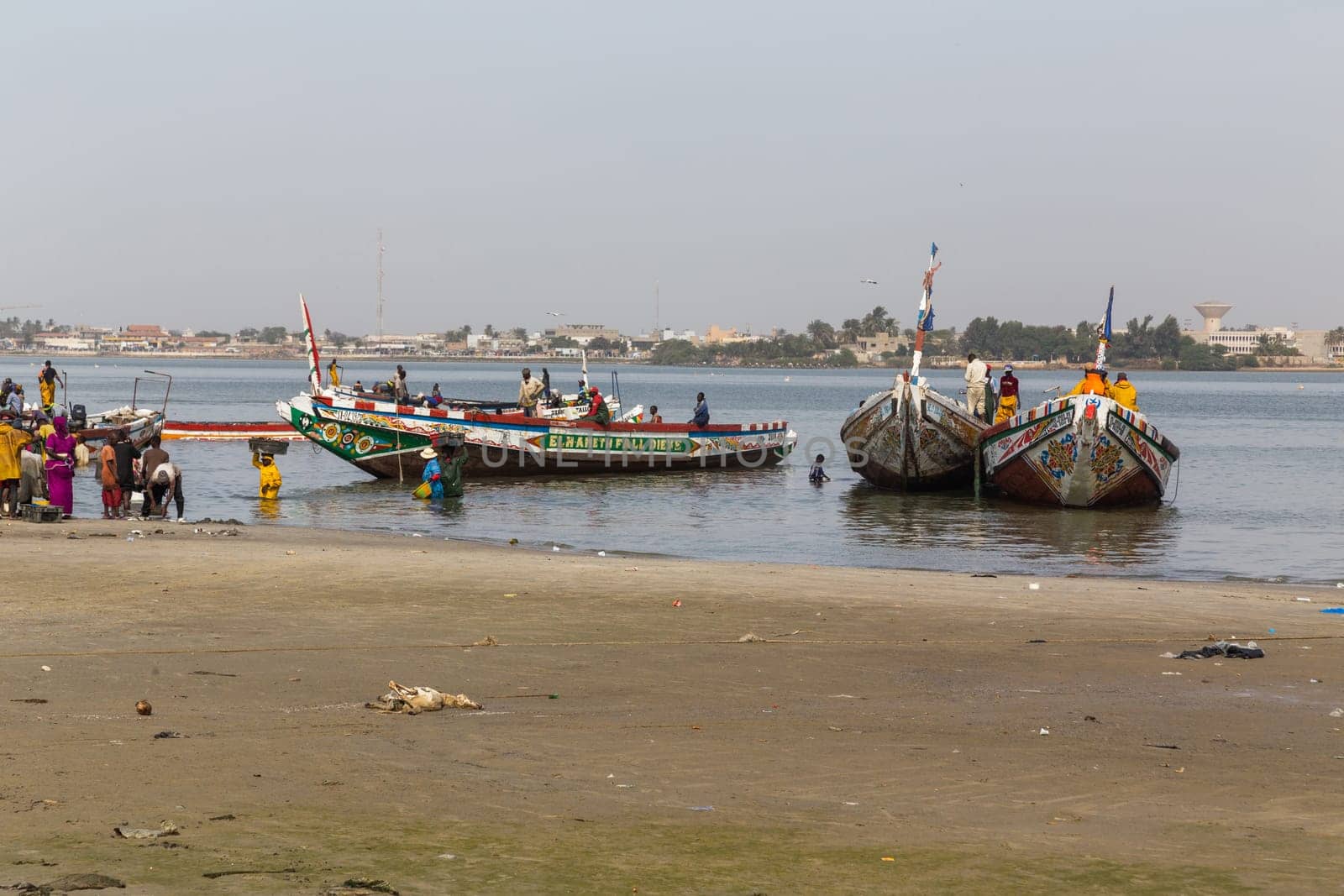 Dakar, Senegal. August 18, 2019: Fishermen with a fishing boat in a beach at Dakar, one of the many fishing beaches of Dakar, Senegal, West Africa