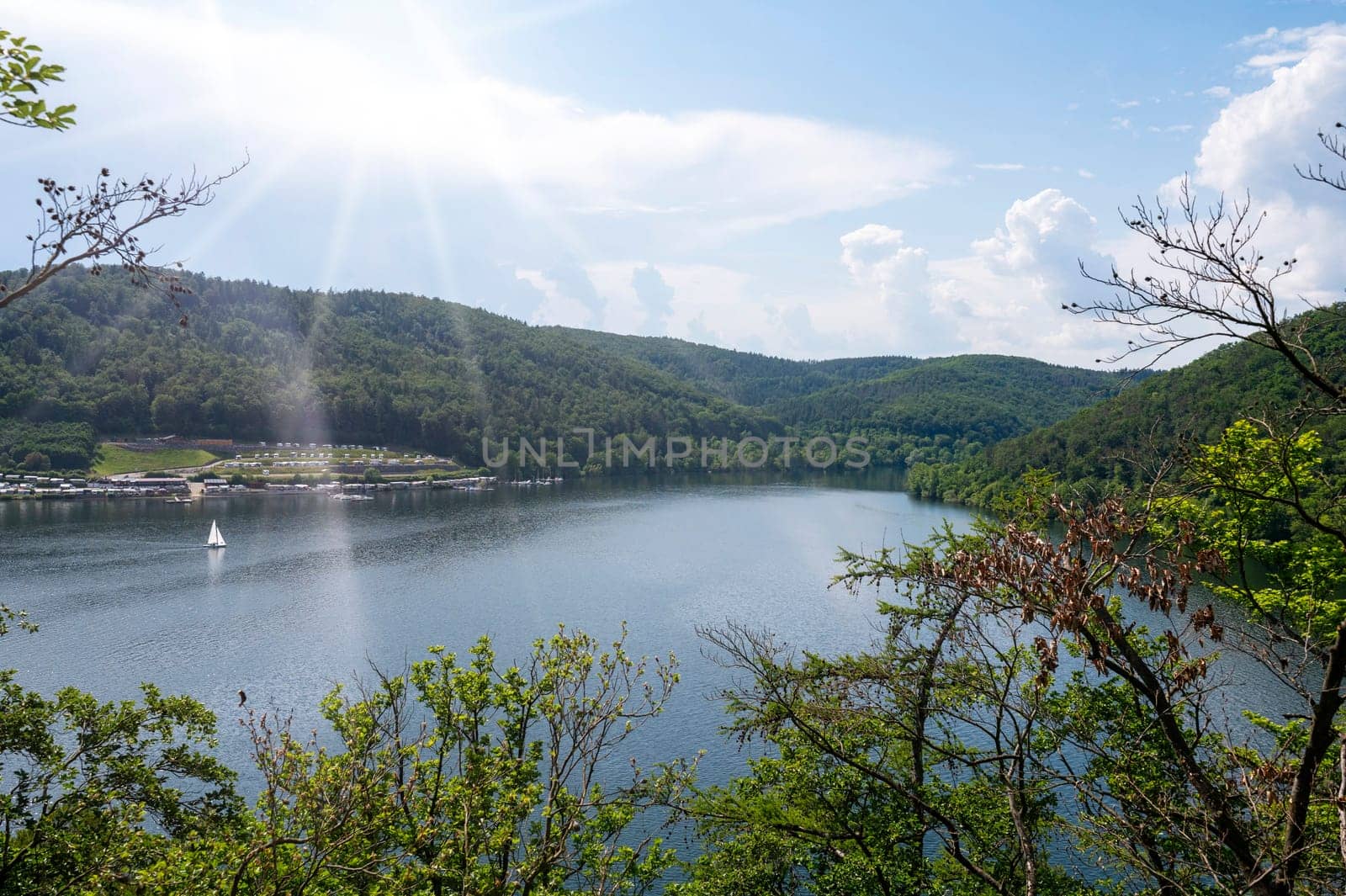 View of the Lake Eder with sky,sunrays, sailing ship and clouds, Hesse, Germany