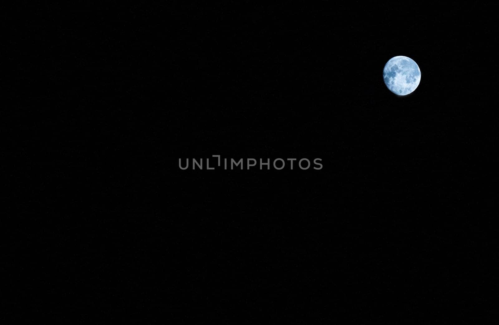 The round moon is blue with spots on a black background in the upper right corner.
