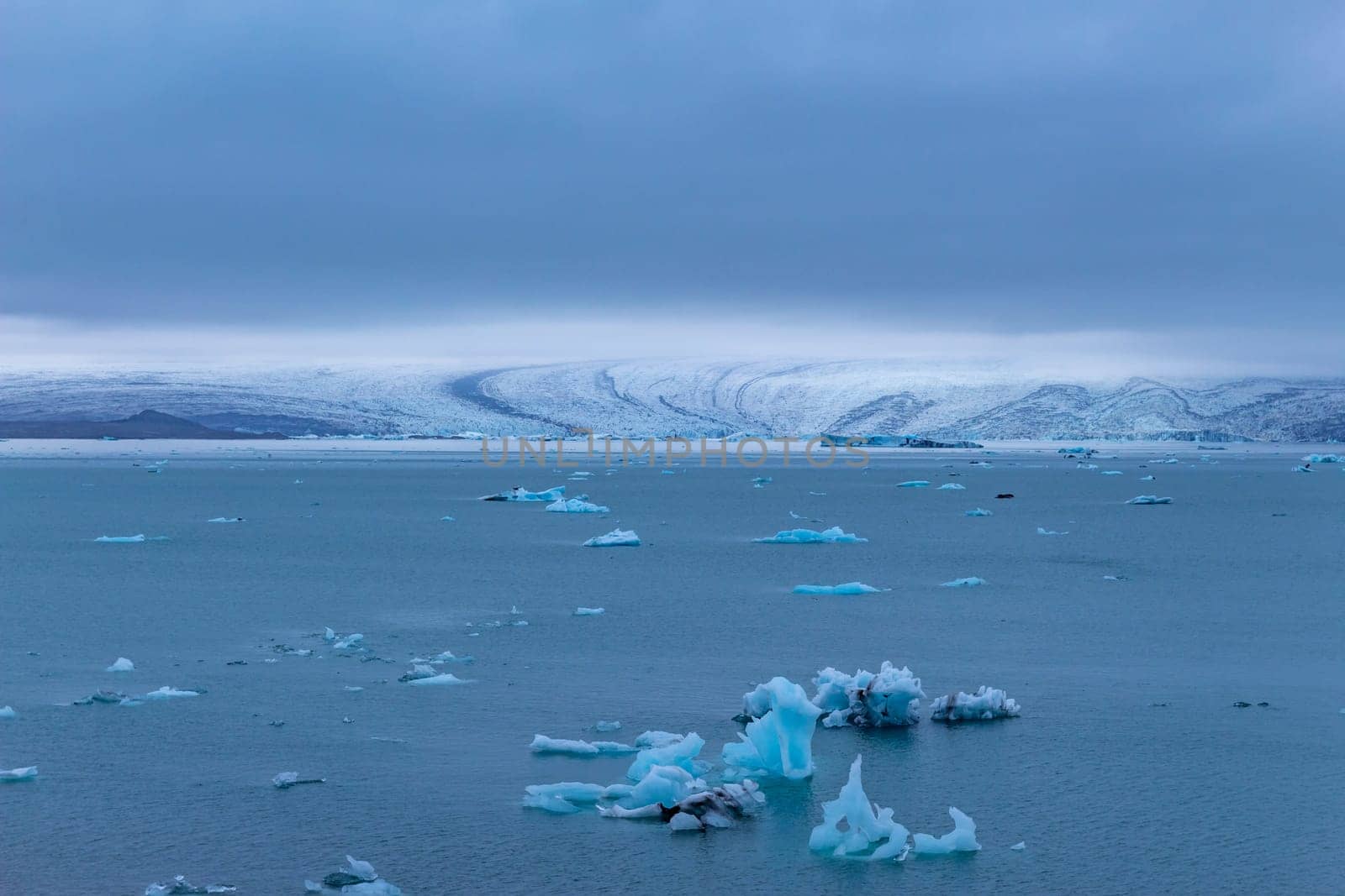 Beautiful blue icebergs reflected in the Jokulsarlon glacial lagoon. Southern Iceland. Part of the Vatnajokull National Park and Vatnajokull glacier, the largest glacier in Europe.