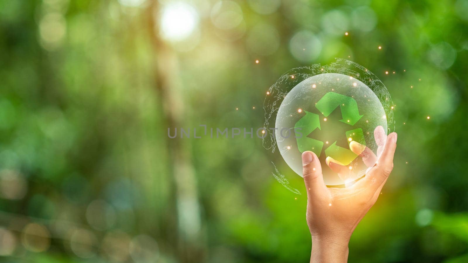 Close up of hand holding green recycle symbol. Recycle concept.