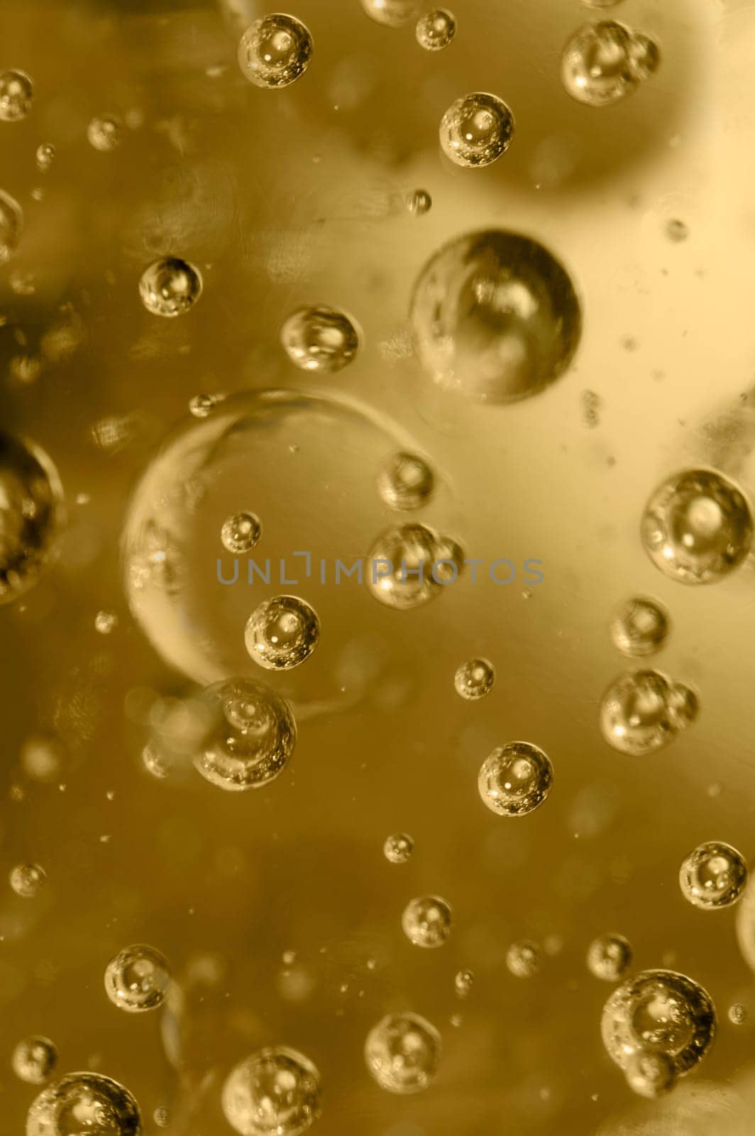 Large and small bubbles in a plastic form of golden color close-up.Texture or background.Selective focus.