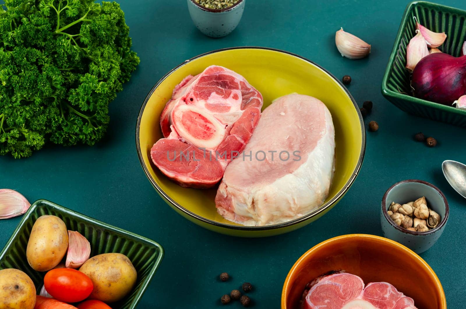 Juicy raw piece meat and vegetables on the kitchen table. Set of ingredients for soup or borscht.