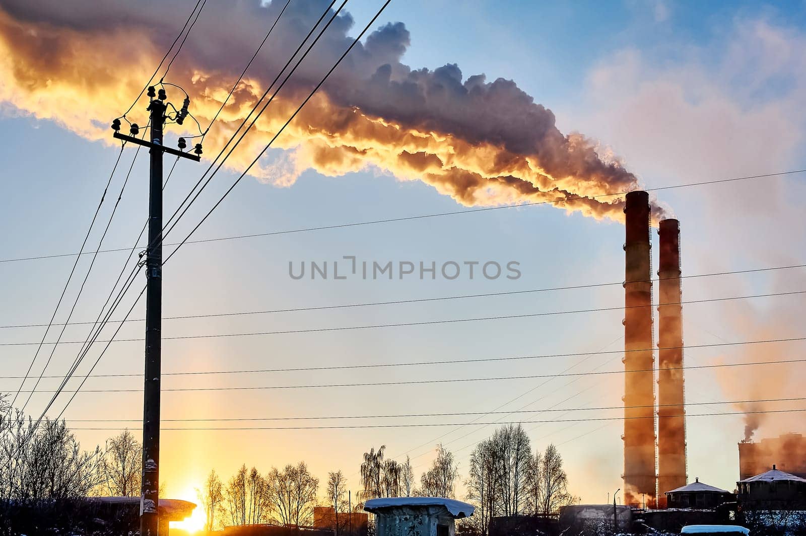 white smoke is coming out of the pipes in the blue sky. High quality photo