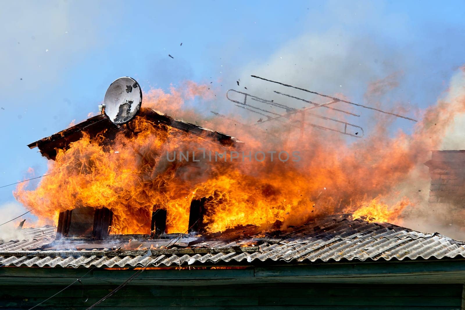 fire on the roof of a wooden house. High quality photo