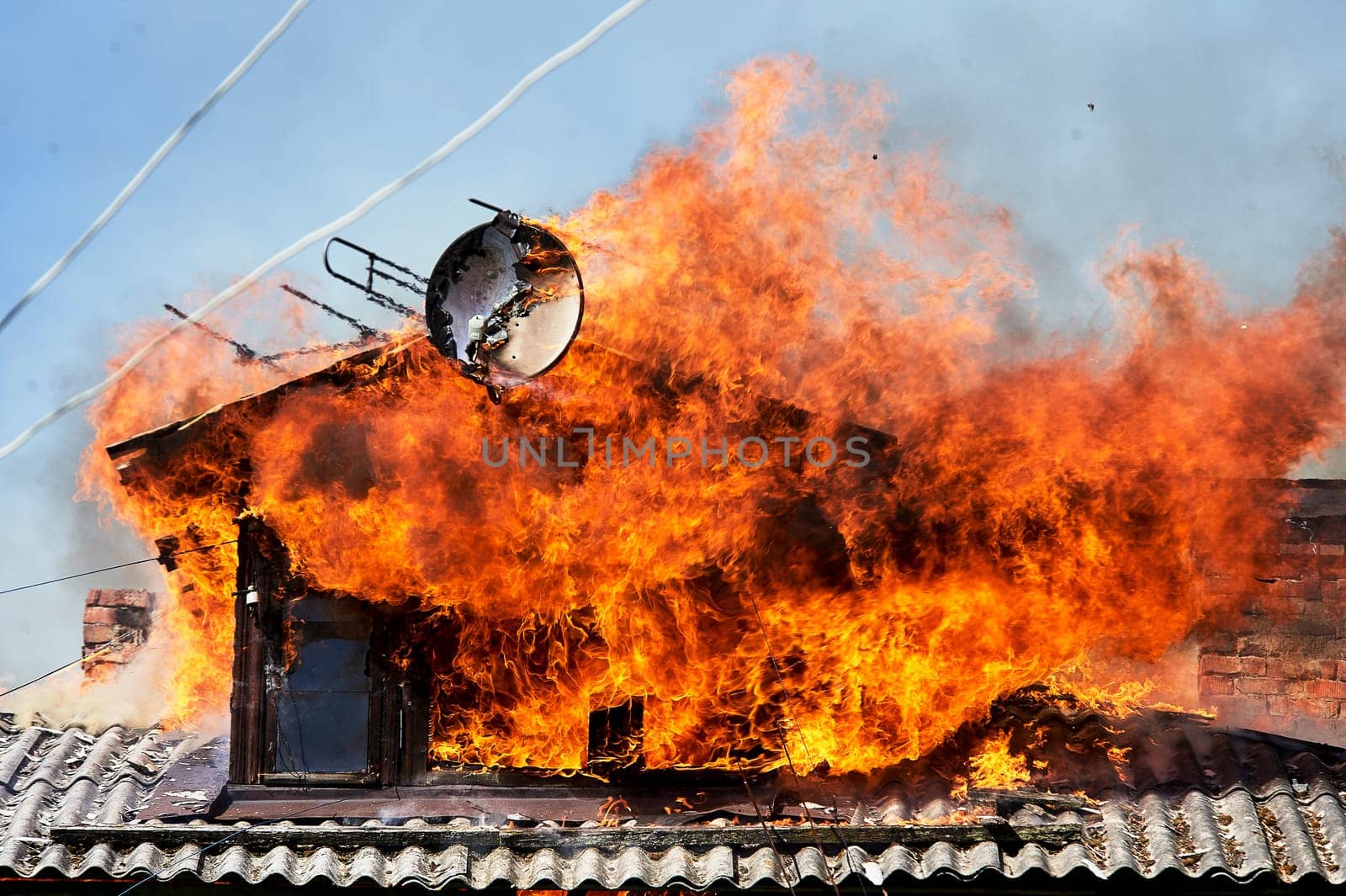 fire on the roof of a wooden house. High quality photo