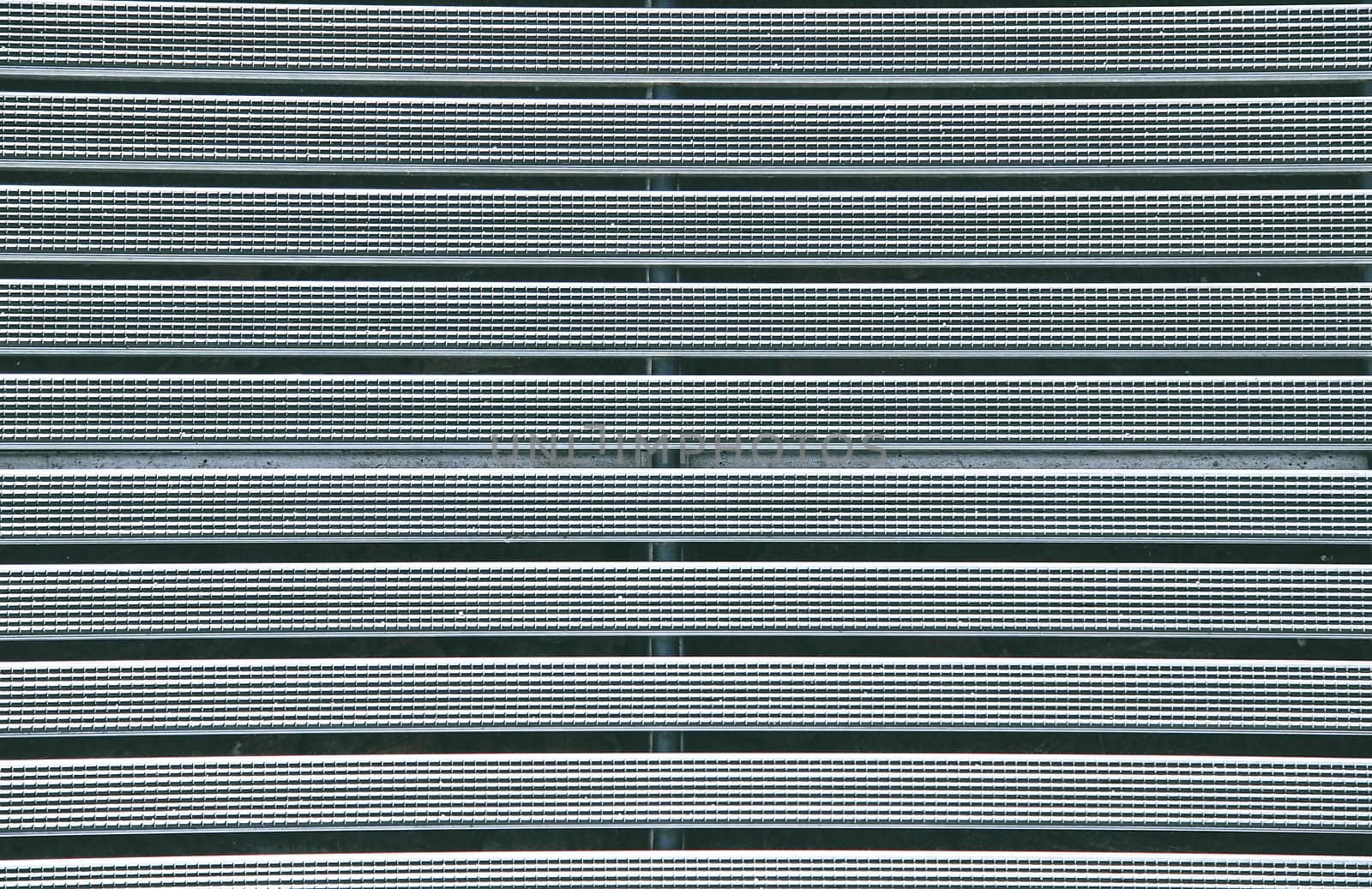 Metal grille with a textured rubber coating in gray color close-up view from above.Texture or background