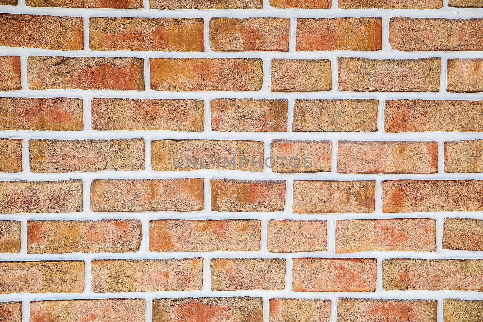 The brick wall is made of decorative aged orange brick.Texture or background