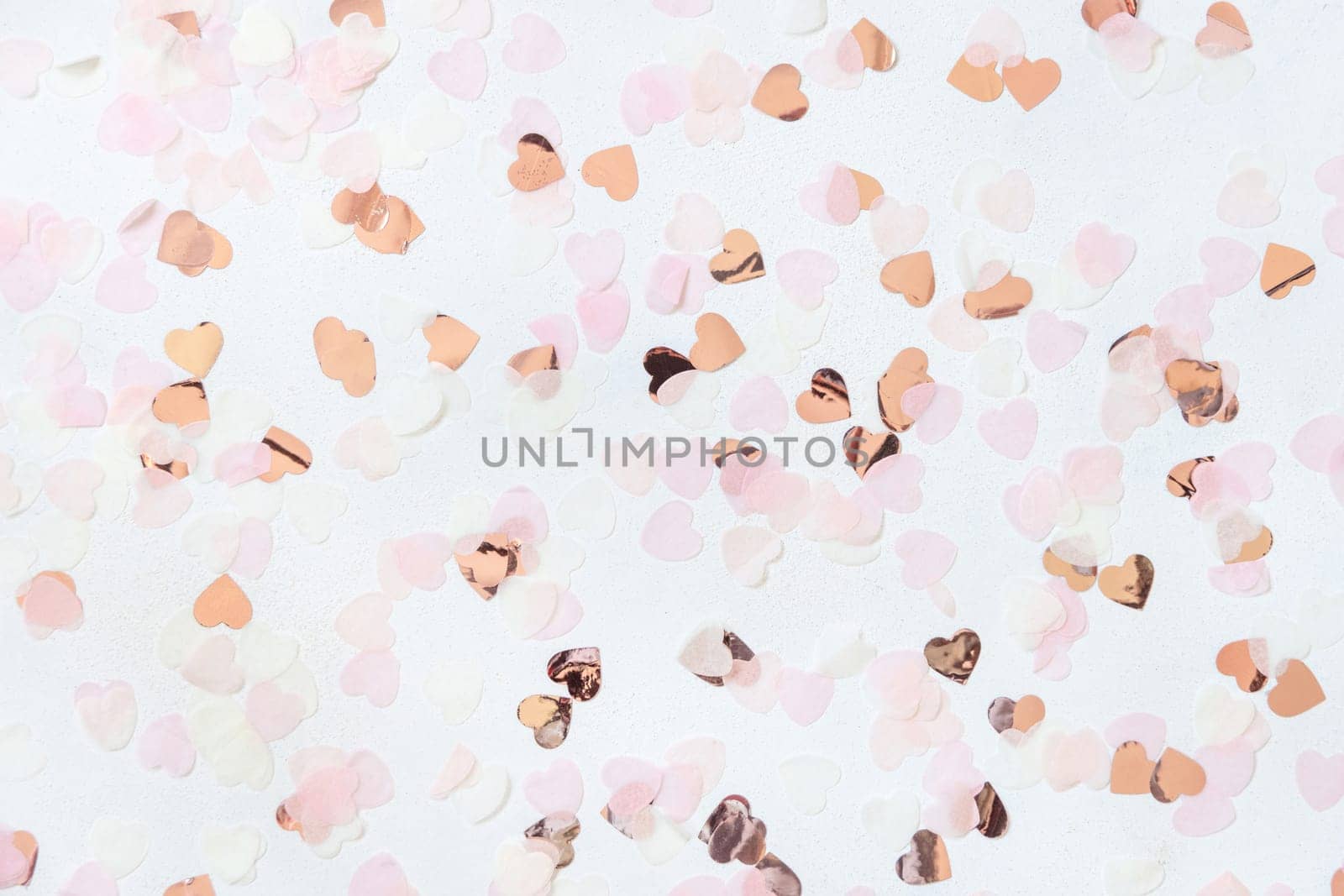 Pink and golden hearts on white table top view. Romantic Wedding, Valentines, Spring or Mothers day background