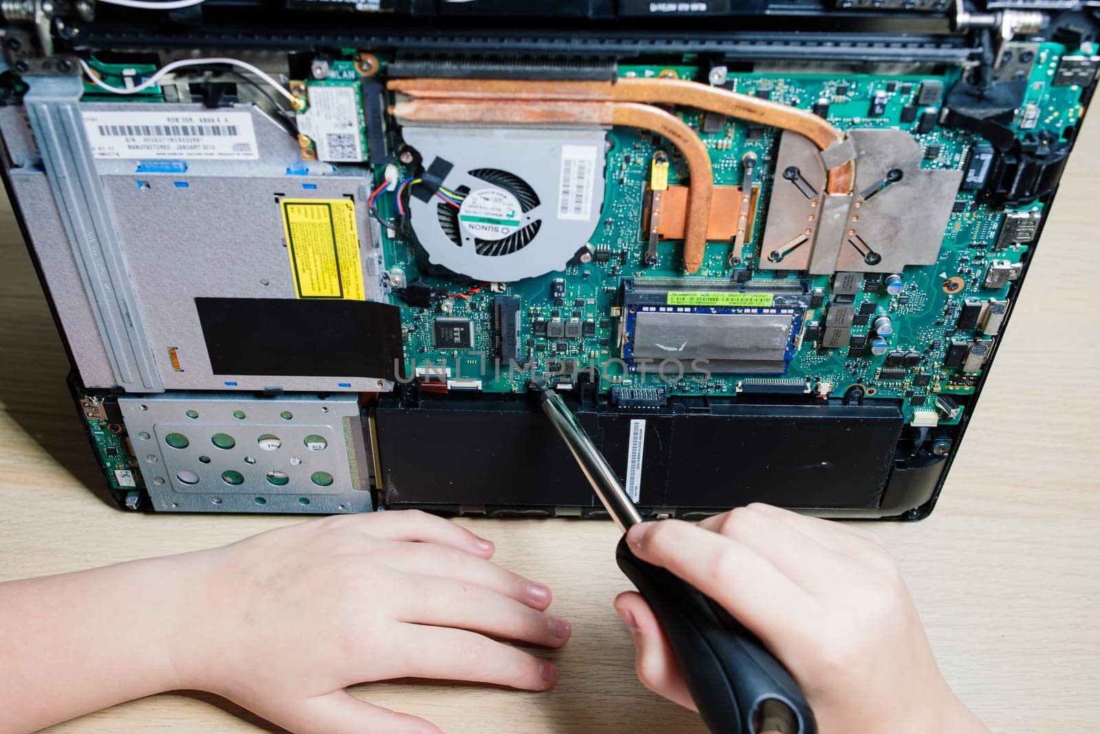 Service engineer install new chips to laptop. Repairing and upgrading laptop concept. Close up.