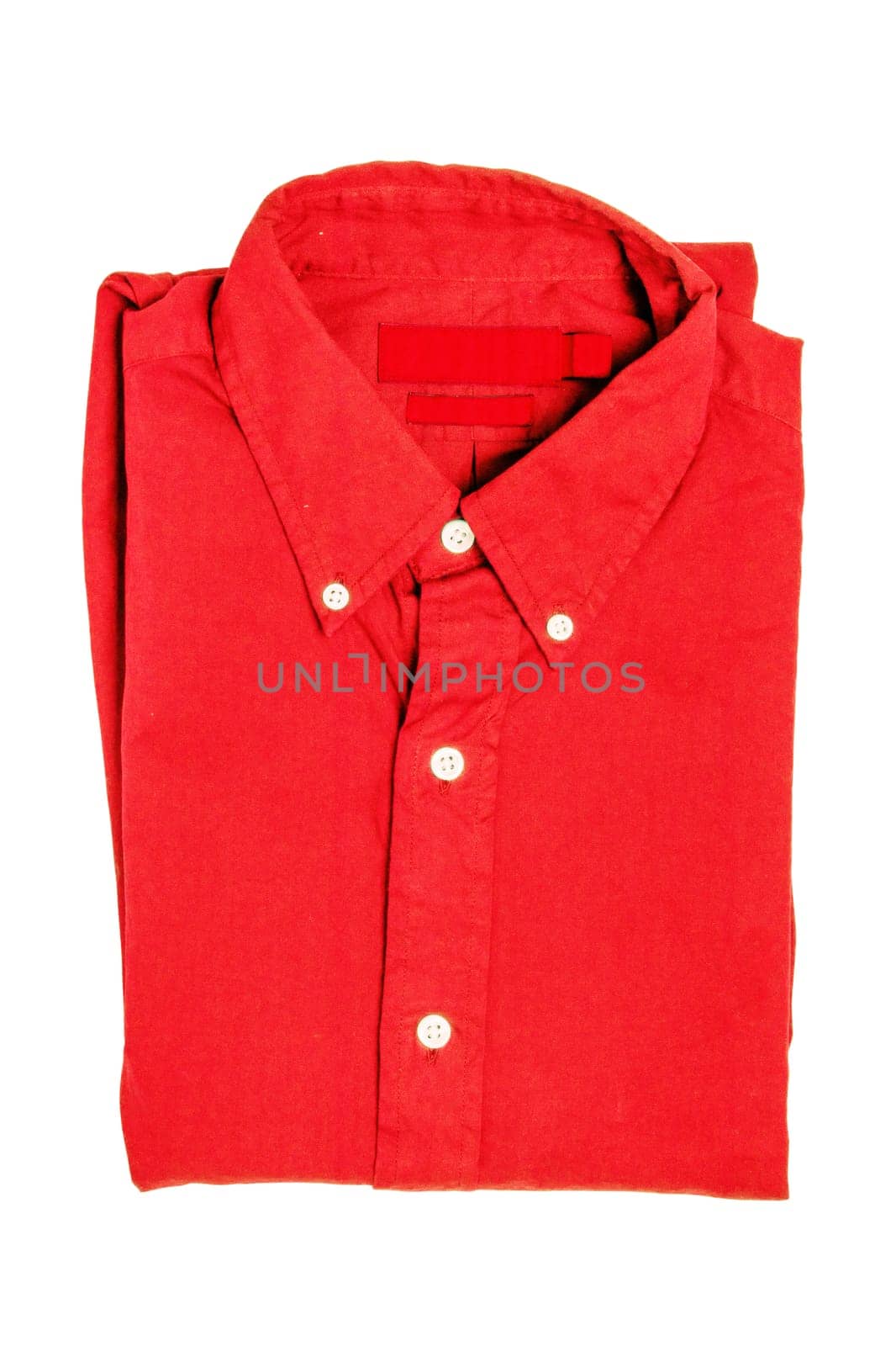 Folded clothes. Close-up of a  new red business shirt isolated on a white background. Mens shirt. Clipping path. Summer fashion. Background texture with space.