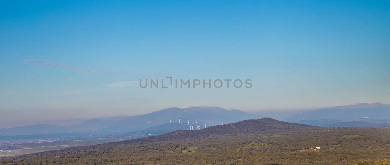 Wind turbines seen from Palancar Convent, Pedroso de Acim, Caceres, Spain. Industrialization of the countryside concept