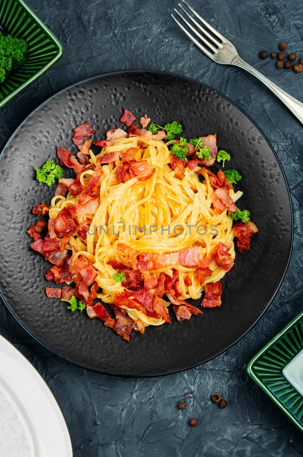 Pasta with carbonara sauce, bacon, parmesan and eggs. Top view.