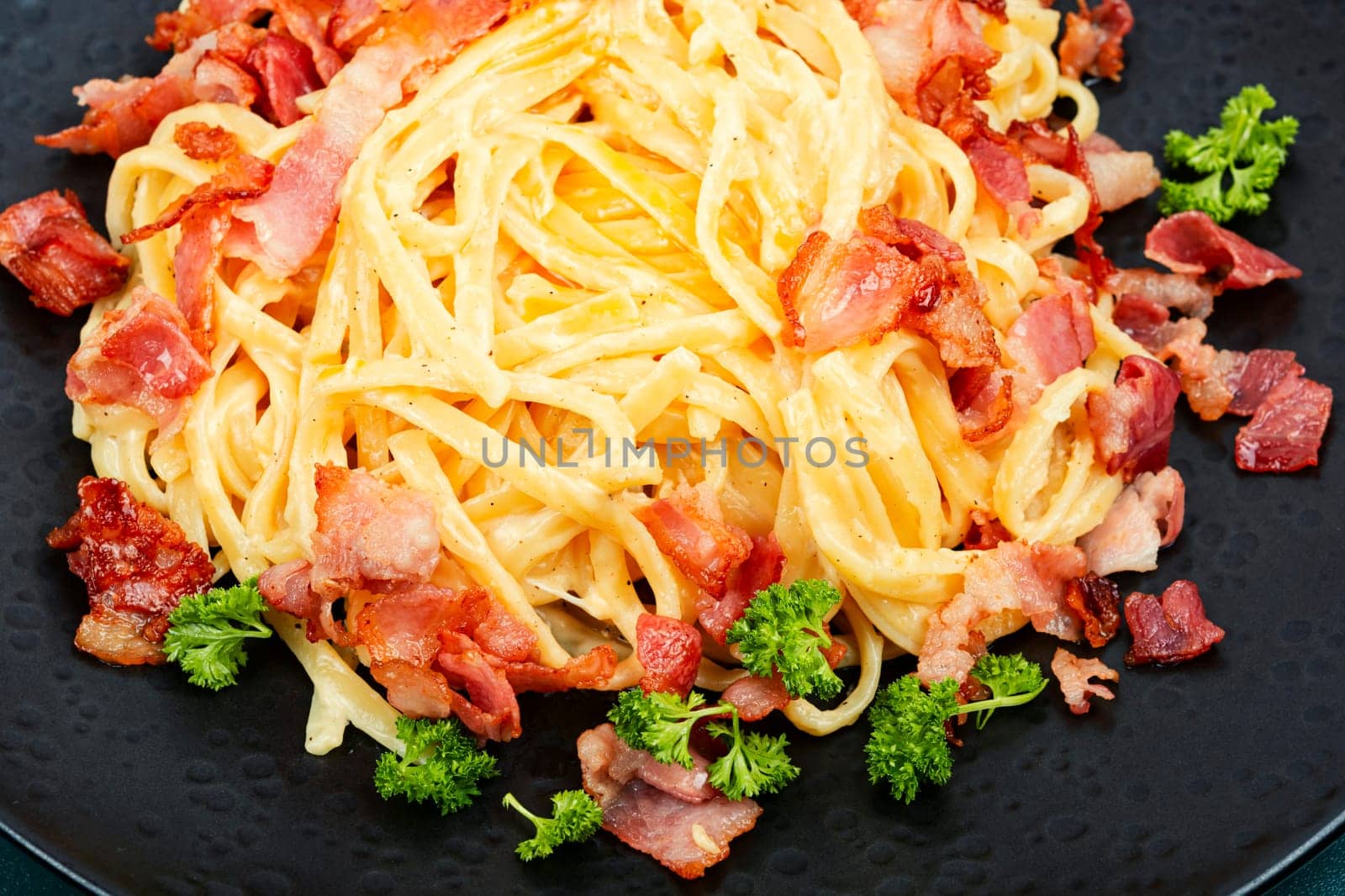 Pasta with carbonara sauce, bacon, parmesan and eggs. Top view.