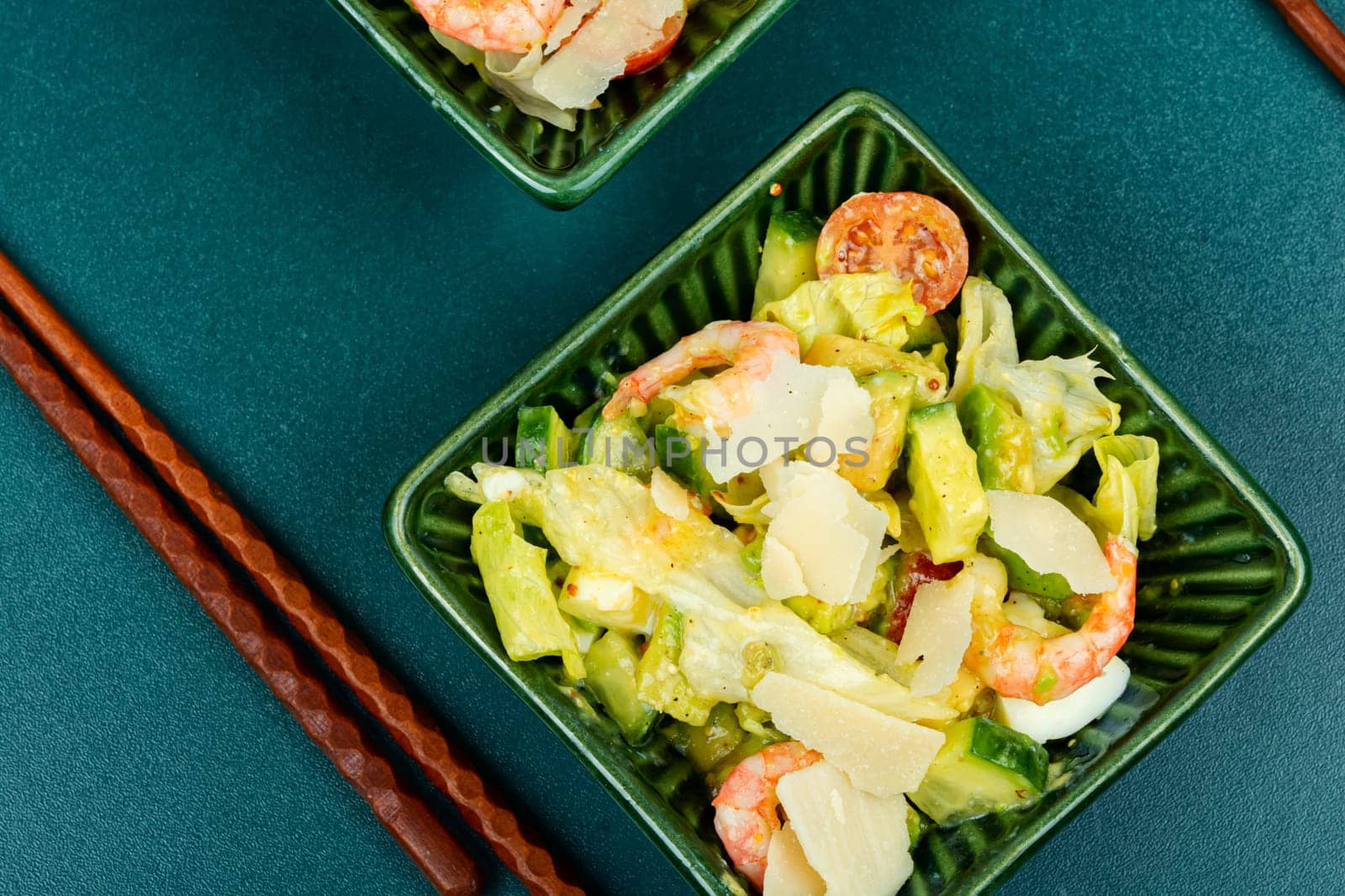Asian salad with shrimps ,prawns avocado slices and tomato. Top view, close up.