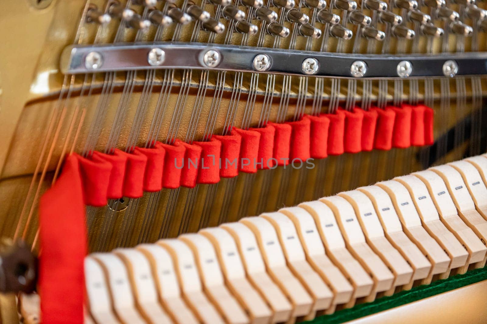 Shallow focus close-up of tools for tuning the internal mechanisms of an upright piano. Gives a feeling of luxury, classic, luxury, grandeur. Pictures can be used on various topics related to music.