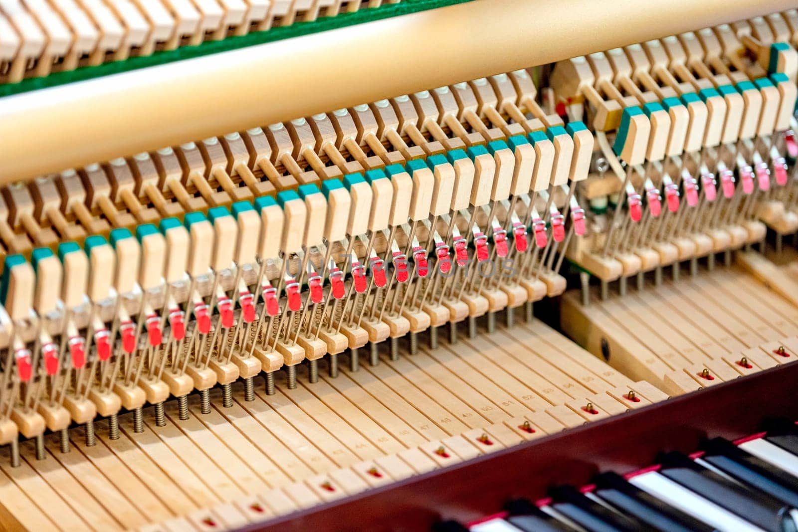 Close-up shallow focus image of the internal mechanisms of an upright piano. It gives a feeling of luxury, beauty, classic, sophistication, elegance. Image can be use for various topics about music.