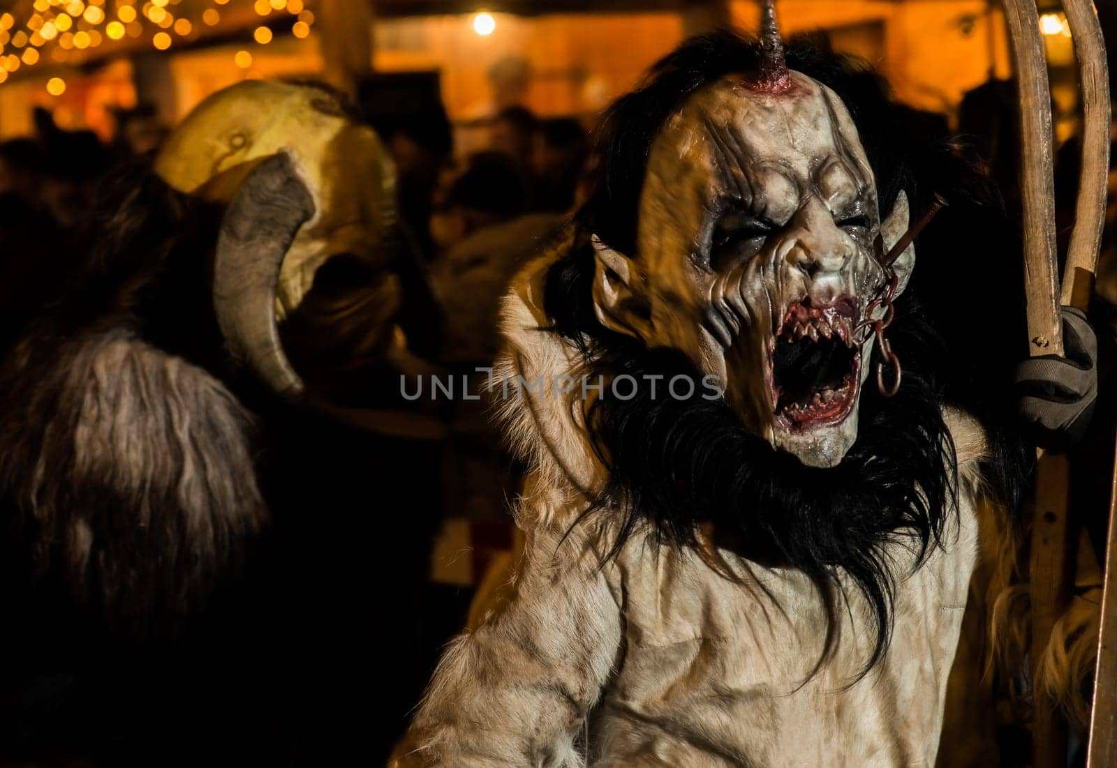 Villach, Austria - November 29, 2019: A Krampus, a horned, anthropomorphic pre-christian traditional figure in the Alpine Region, at the yearly Perchtenlauf in Villach.