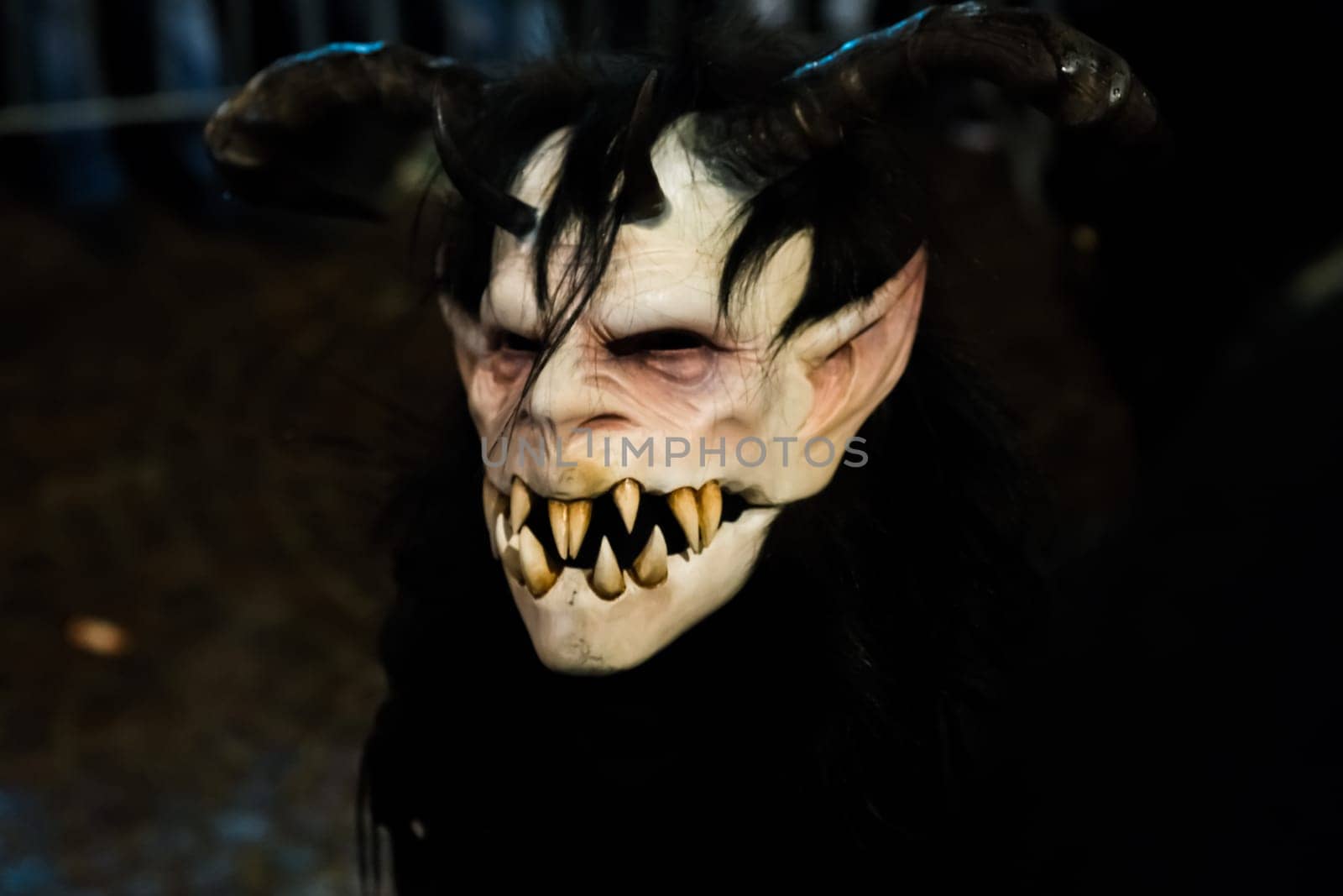 Villach, Austria - November 29, 2019: A Krampus, a horned, anthropomorphic pre-christian traditional figure in the Alpine Region, at the yearly Perchtenlauf in Villach.