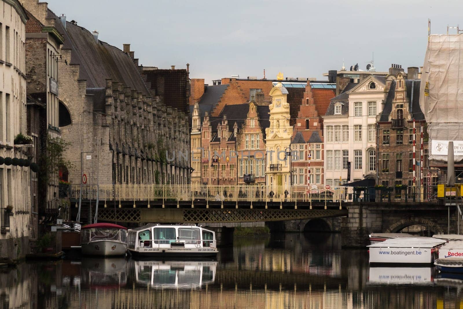 Ghent, Belgium - June, 10th 2019: Old houses shining in the morning sun light in medieval Ghent.