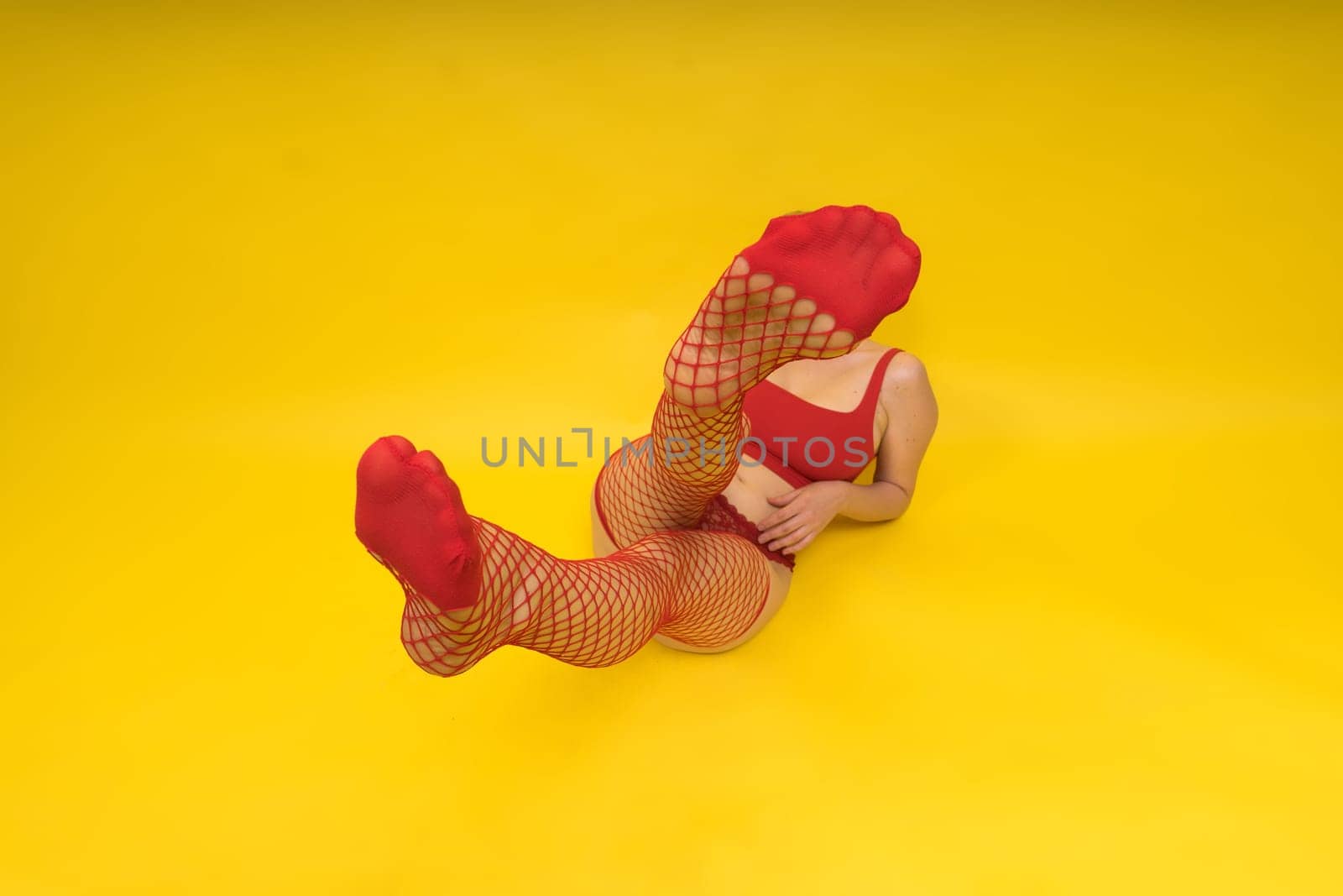 Seductive attractive blonde woman posing in fashionable lingerie in a studio