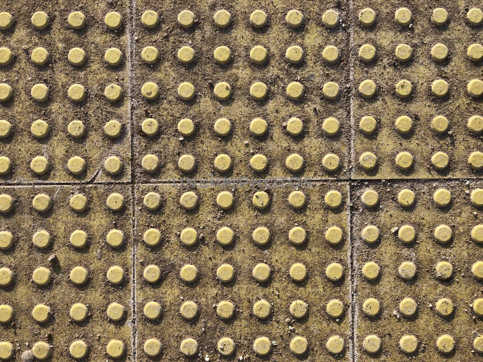 yellow tactile pavement tiles for the blind, background