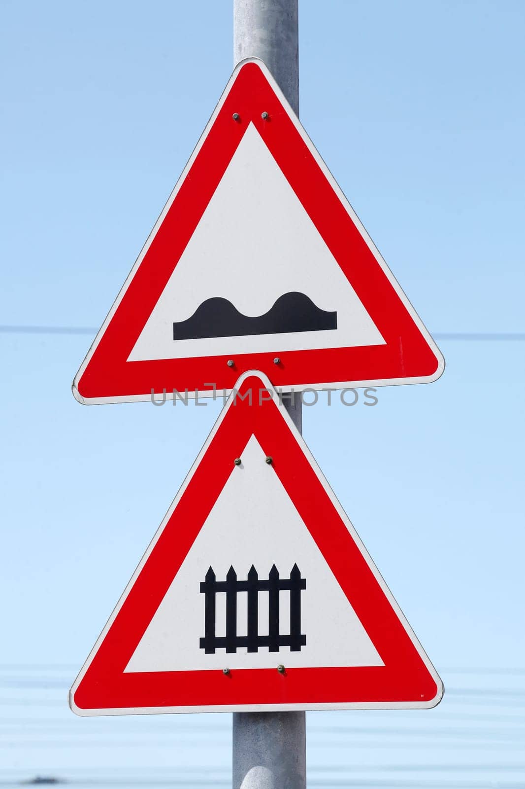 Danger sign, traffic sign for gated level crossing, uneven roadway, Germany
