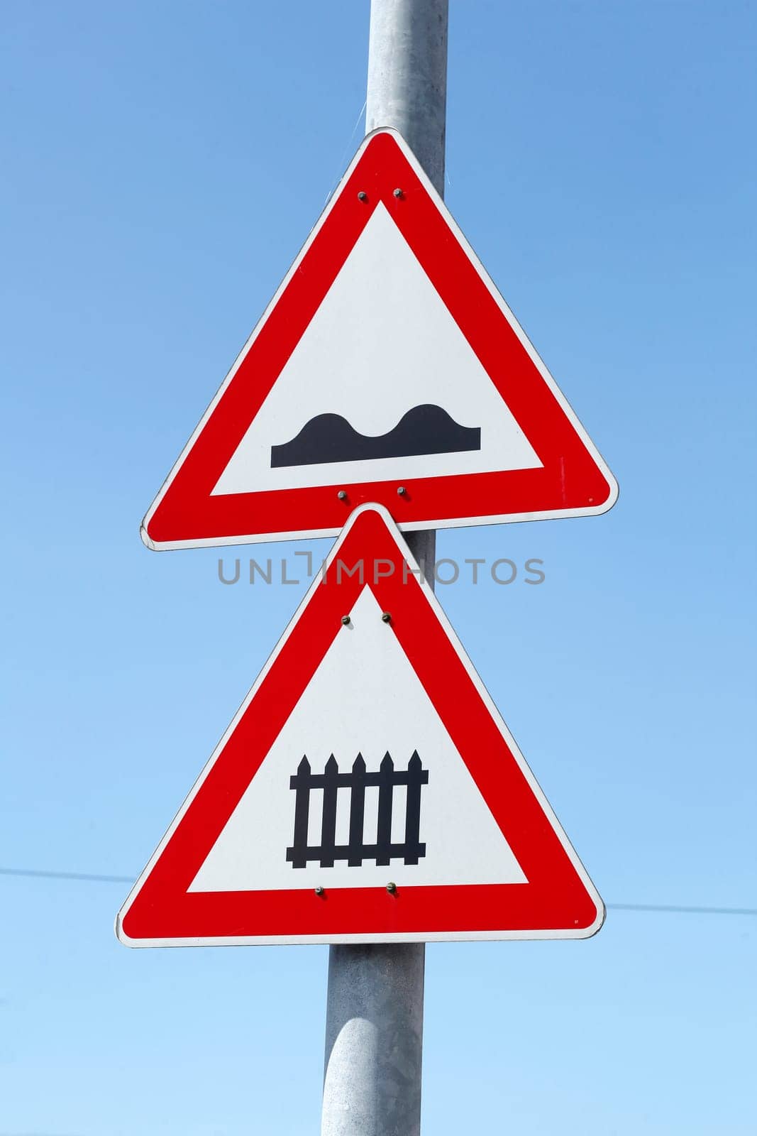 Danger sign, traffic sign for gated level crossing, uneven roadway, Germany