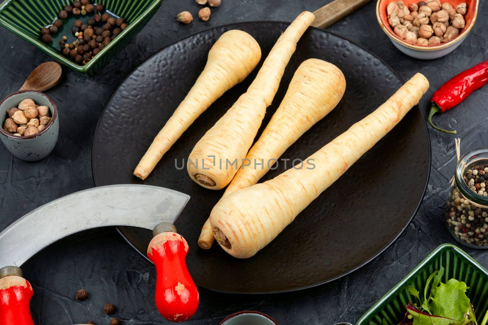 Raw and uncooked whole parsnips roots on the kitchen table