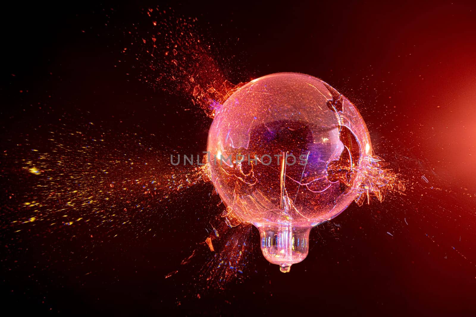 explosion of a glass bulb on a black background. high-speed photography