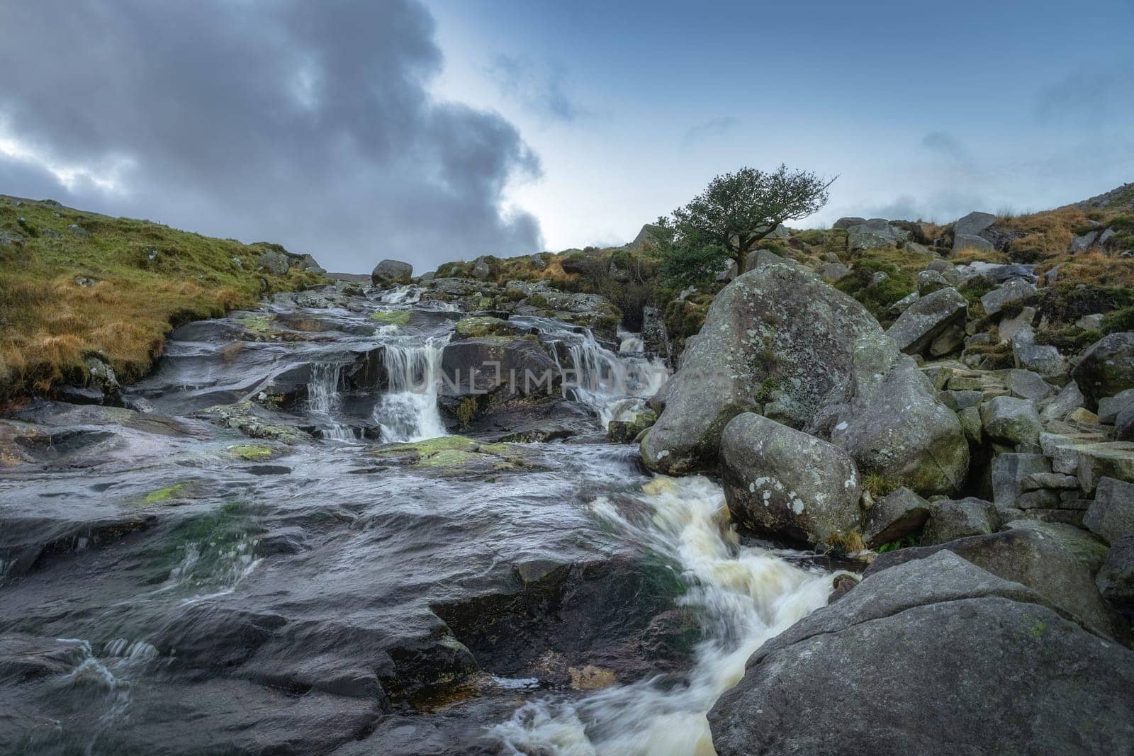 Stream with small waterfalls and cascades in Glendalough. Hiking in beautiful autumn Wicklow Mountains, Ireland