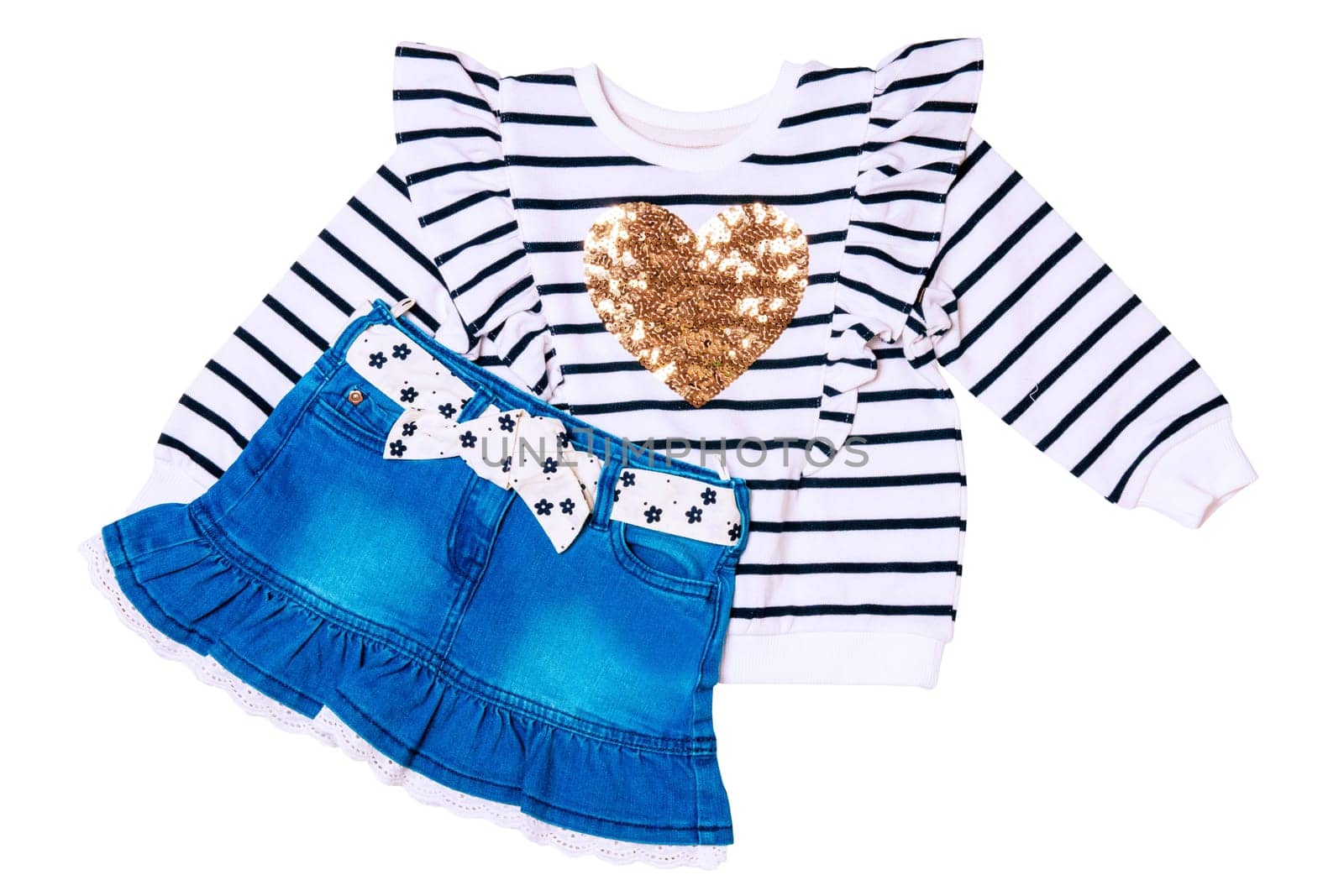 A black and white striped sweater or pullover with a heart and a cute short blue denim skirt with a white fabric belt with flowers and bow isolated. Clipping path.