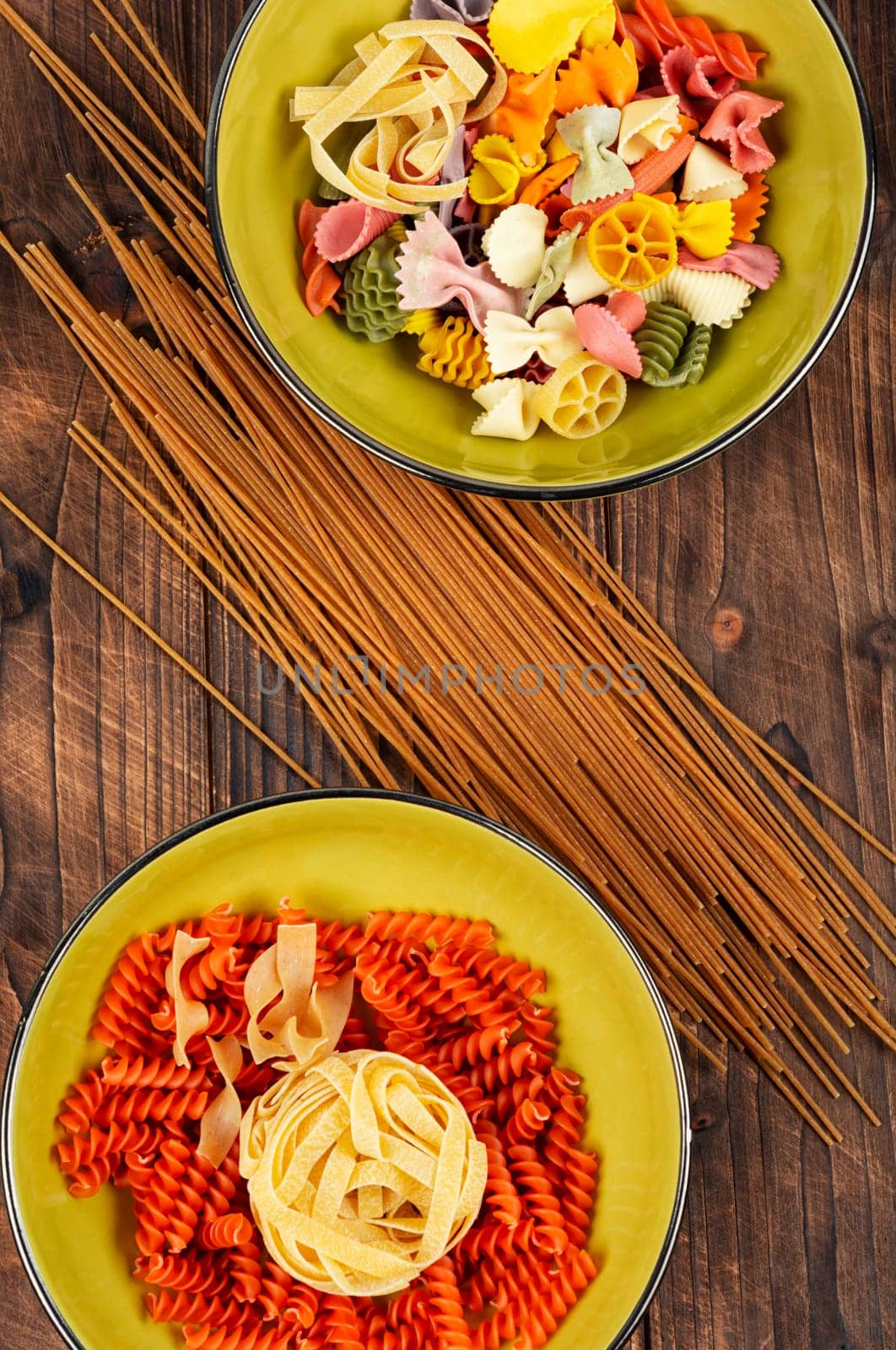 Different sorts of uncooked pasta, macaroni, noodles and spaghetti. Copy space.