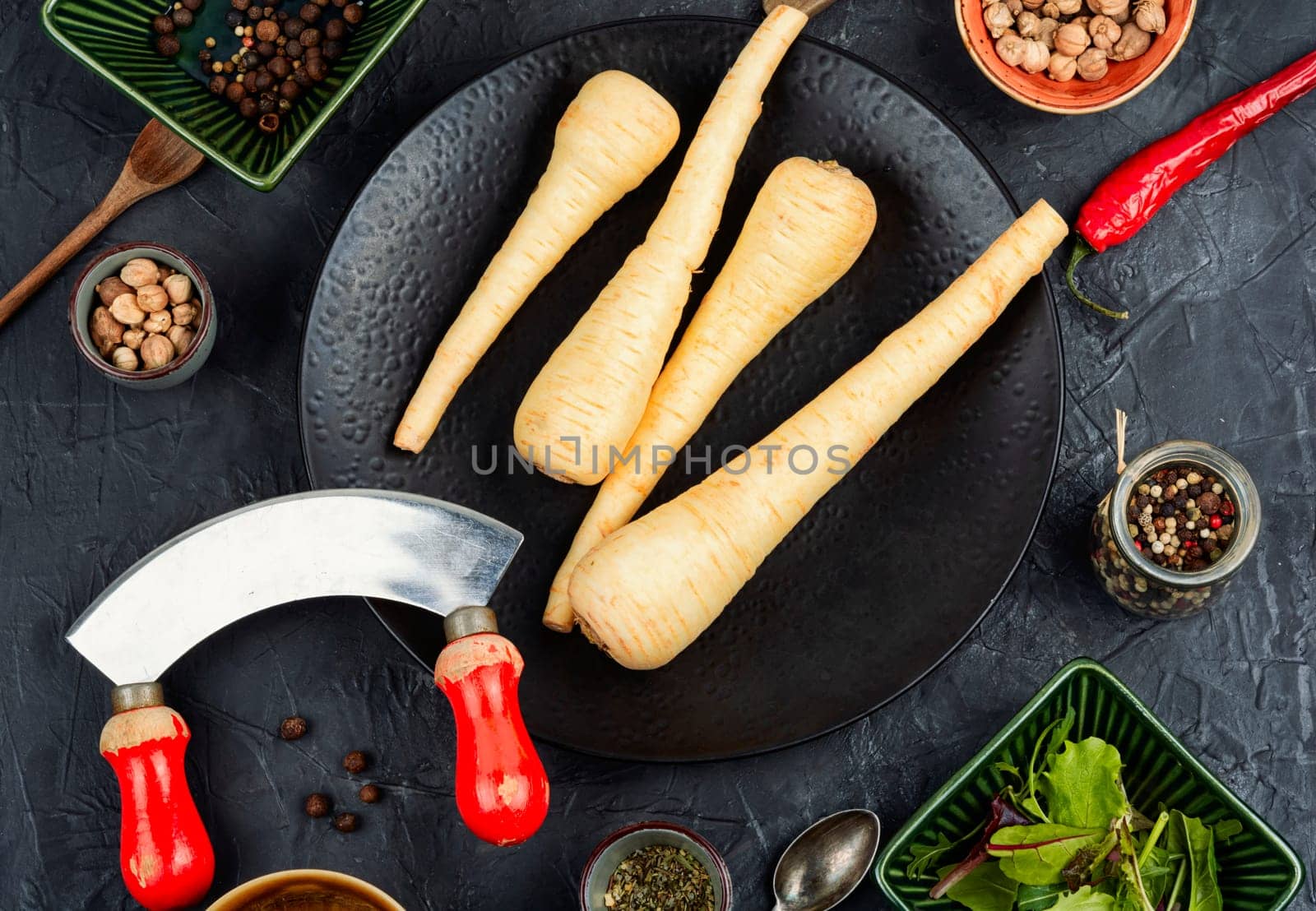 Raw parsnip roots on the kitchen table. Root vegetables. Flat lay.