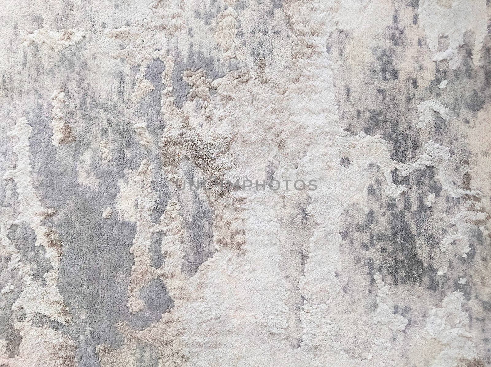 The texture of a short-haired spotted carpet in gray and black tones.Texture or background