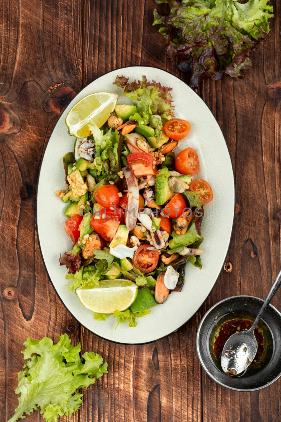 Mix salad with seafood, shrimp, scallop, octopus, squid and fresh vegetables.