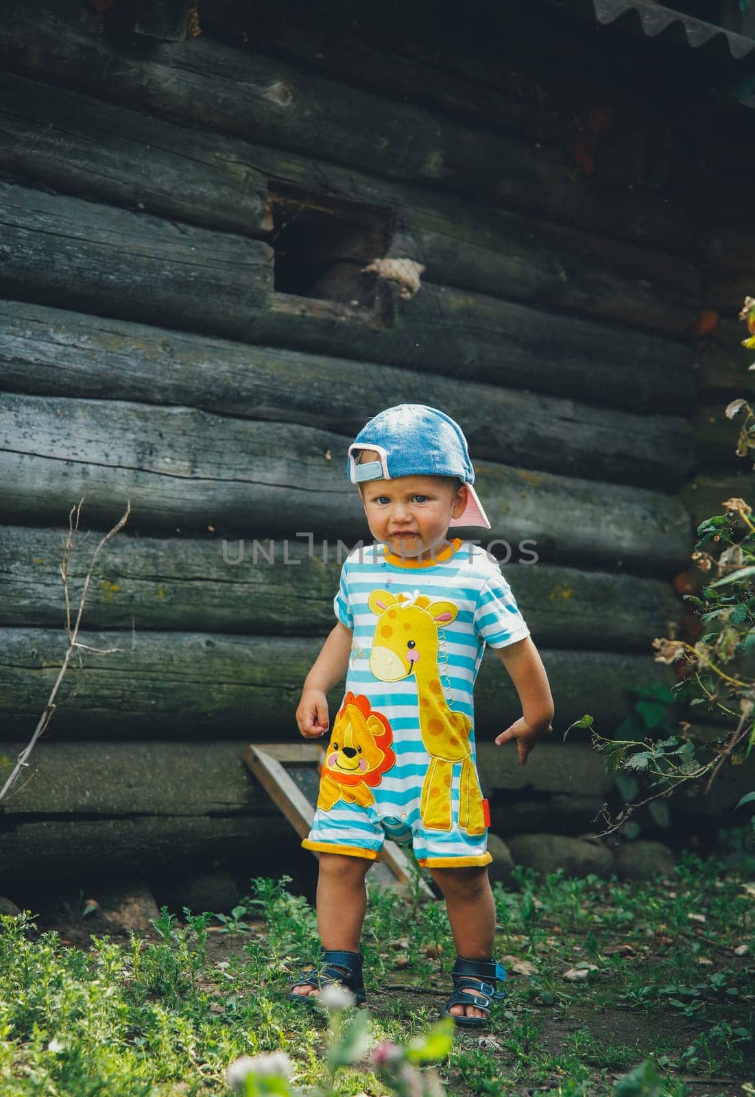 A little boy on the street on a summer day
