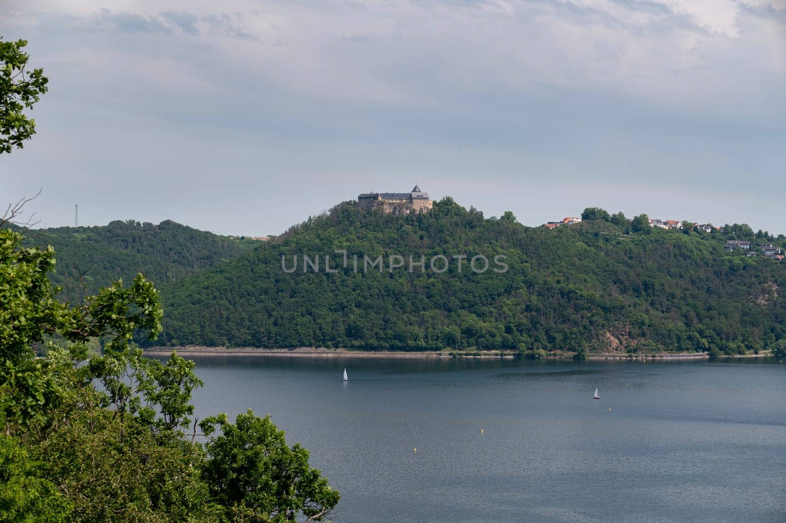 View of the Lake Eder, with a view of a castle, with blue sky and clouds, Hesse, Germany