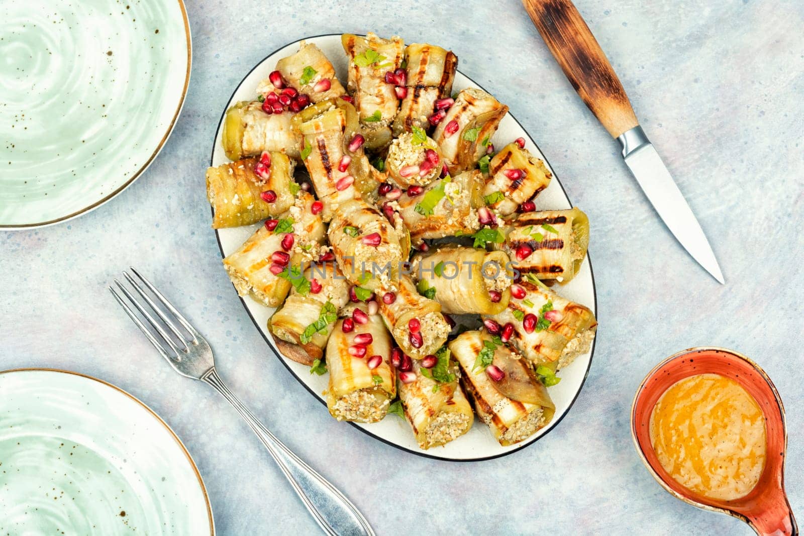 Delicious Badrijani, vegan vegetarian healthy food. Eggplant rolls on the table. Top view.