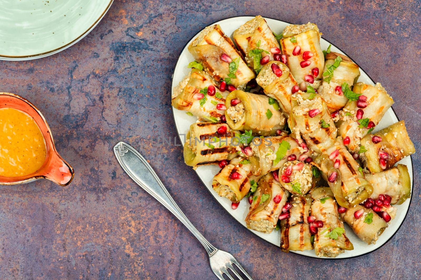 Delicious Badrijani, vegan vegetarian healthy food. Eggplant rolls on the table. Top view.