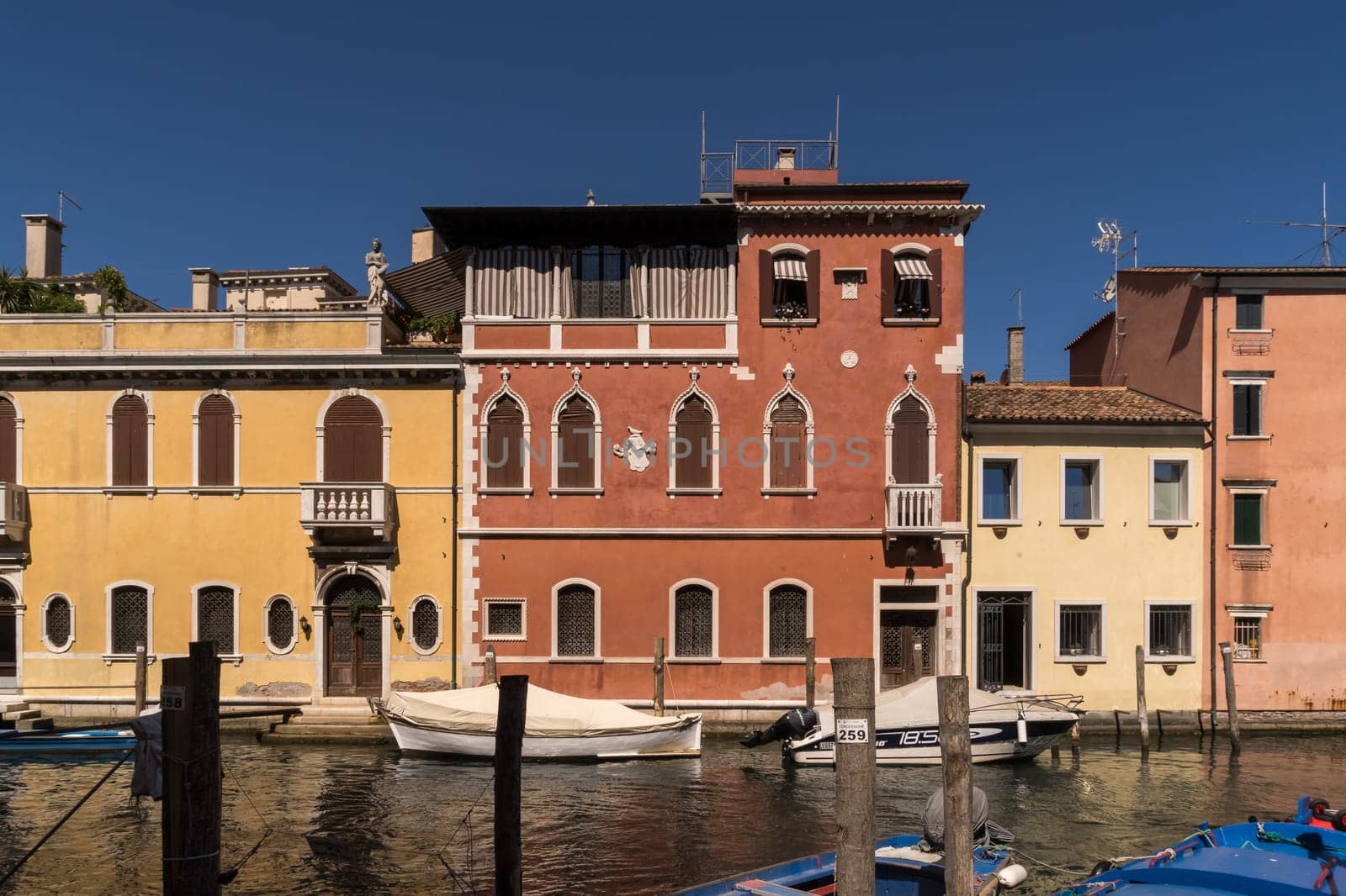 Old houses along one of the canal in the pleasant medieval city of Chioggia.
