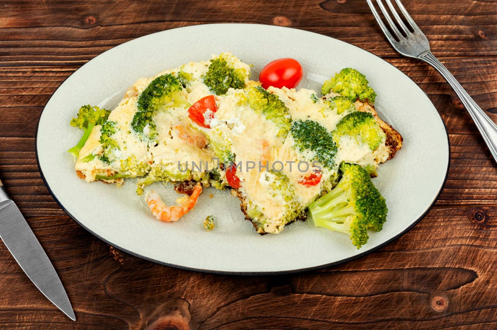 Delicious omelette with broccoli, shrimp and tomato. Ketogenic lunch.