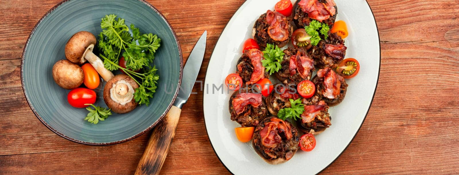 Homemade champignon mushrooms stuffed with minced meat and bacon. Copy space.