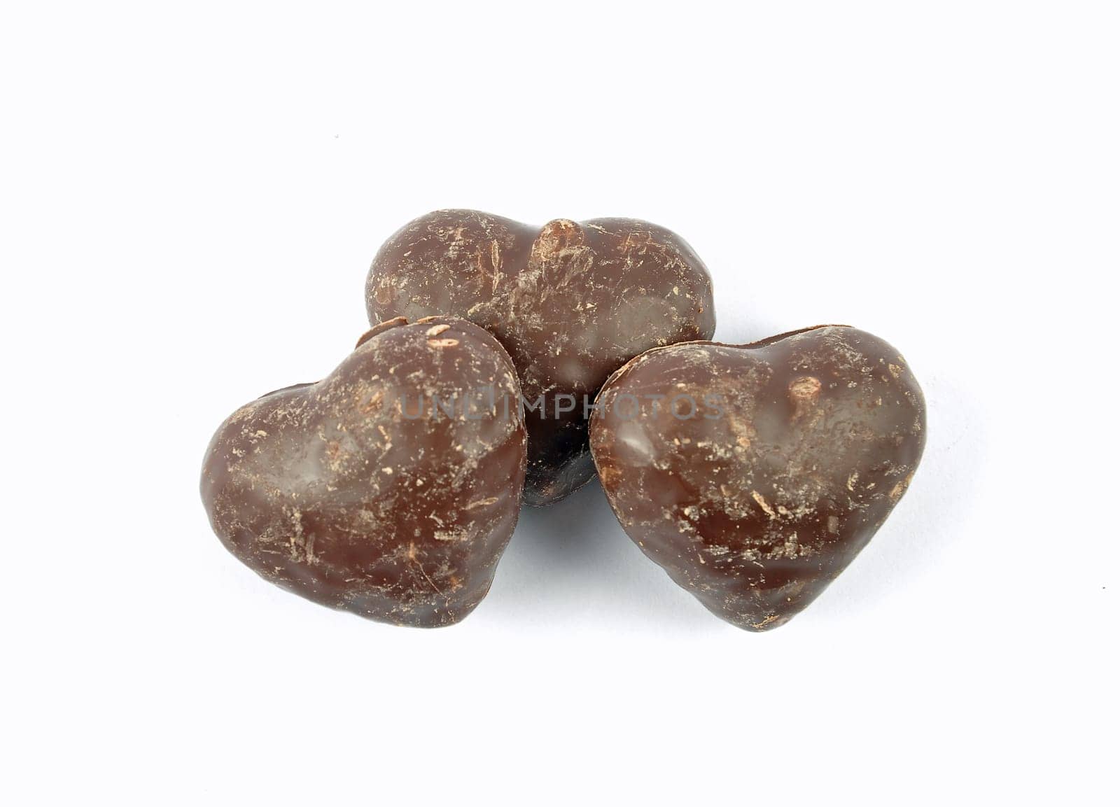 Small gingerbread hearts stacked and isolated on white background